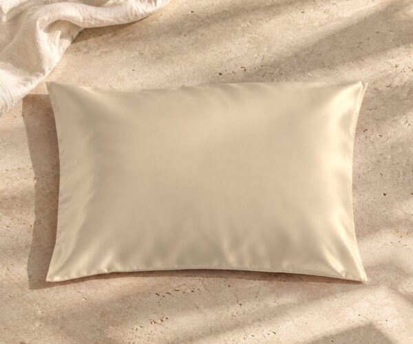 Beige mulberry silk pillowcase on sunlit stone