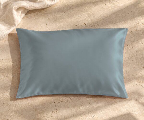 Grey blue mulberry silk pillowcase on sunlit stone