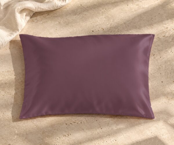 Grey purple mulberry silk pillowcase on sunlit stone