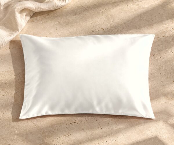 Ivory mulberry silk pillowcase on sunlit stone