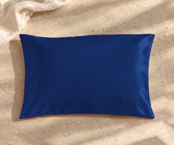 Navy blue mulberry silk pillowcase on sunlit stone