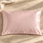 Blush pink mulberry silk pillowcase on sunlit stone