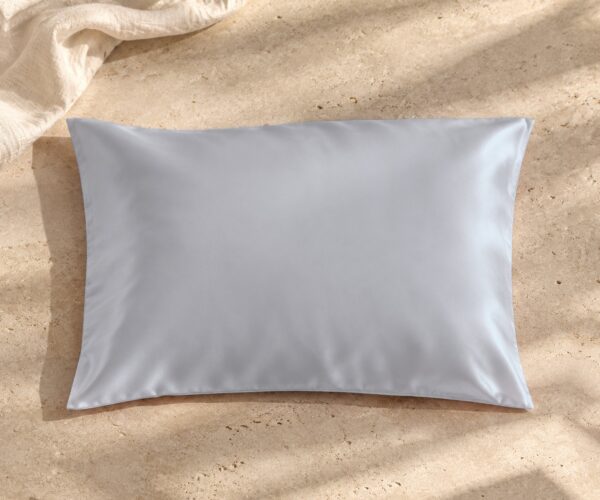 Silver mulberry silk pillowcase on sunlit stone