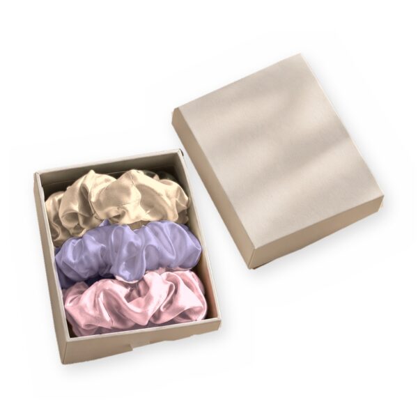 Curio Silk silk scrunchie gift box in champagne pink lavender on a white background