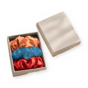 Curio Silk silk scrunchie gift box in coral red azure on a white background